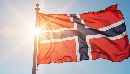 Norwegian flag waving in bright sunlight and blue sky