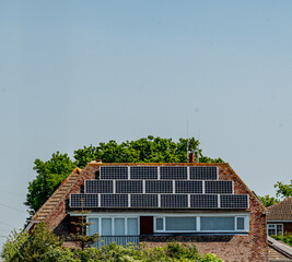 Solar panels on a residential roof capturing the sun's energy and converting it to electricity.