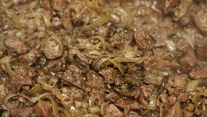 Frying Chicken Liver with Onions in Hot Skillet.