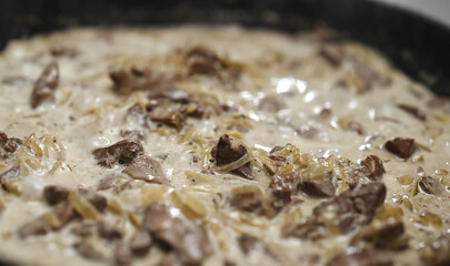 Chicken Liver and Onions Simmering in Cream Sauce.