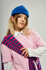 Stylish young woman in blue beanie brings a fresh look to a modern studio setting