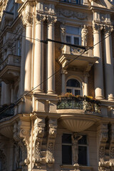 A close-up, low-angle view highlights the ornate corner of a historic building facade, richly...
