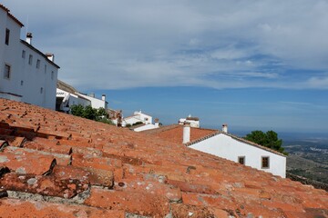 Fototapeta premium Rooftops made of terracotta tiles establish a charming view of a traditional village perched on a hillside