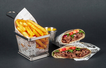 Delicious Beef Wrap Shawarma with Fresh Vegetables and French Fries