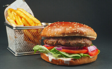 Fresh beef burger with Crispy French fries on black background