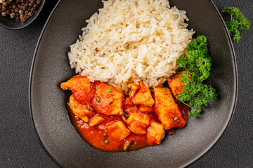 Rice butter chicken curry chicken tikka masala spicy meat in a bowl on the table fresh tasty gourmet food background on rustic food top view copy space