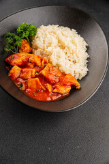 Rice butter chicken curry chicken tikka masala spicy meat in a bowl on the table fresh tasty gourmet food background on rustic food top view copy space