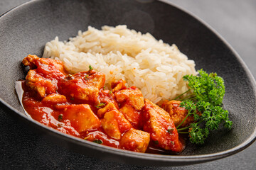Rice butter chicken curry chicken tikka masala spicy meat in a bowl on the table fresh tasty gourmet food background on rustic food top view copy space