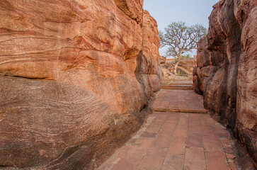 Massive sandstone canyon at Badami, Path through cliffs, Entrance archway for lower and upper...