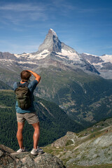 Boy taking pictures of the Matterhorn, Switzerland