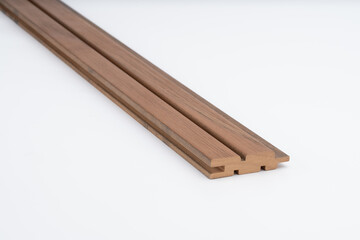 Brown wooden slat profile with deep parallel grooves, shown on a white background. Ideal for acoustic panels, cladding, or modern architectural design..