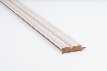 Light-toned wooden slat with milled grooves and smooth surface, placed on white background. Ideal for modern wall panels or ceiling cladding..