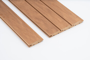 Brown wooden wall panels with tongue-and-groove joints, neatly aligned on a white background. Perfect for acoustic or decorative cladding use..