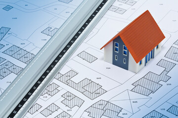 New home and free vacant land for building activity - Construction industry concept with a residential building with and imaginary cadastral map