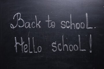 Obraz premium Phrases Back To School and Hello School with exclamation mark on blackboard