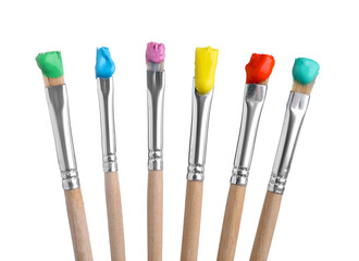 Brushes with different paints isolated on white