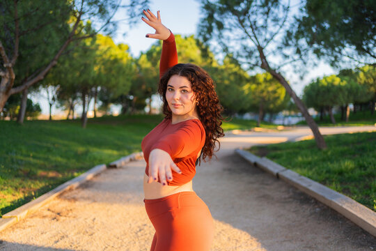 Curvy dancer performing in a park, promoting body positivity and self acceptance