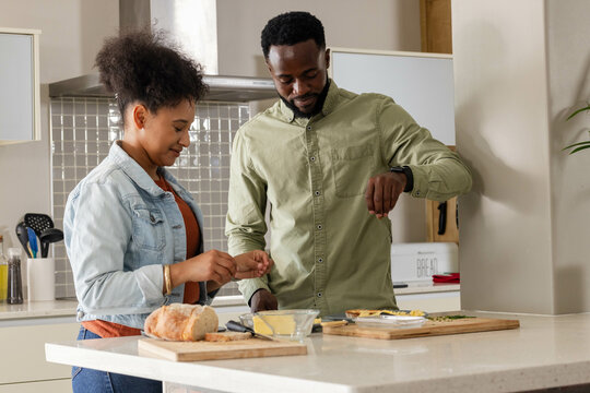 Couple preparing meal together in modern kitchen, enjoying quality time