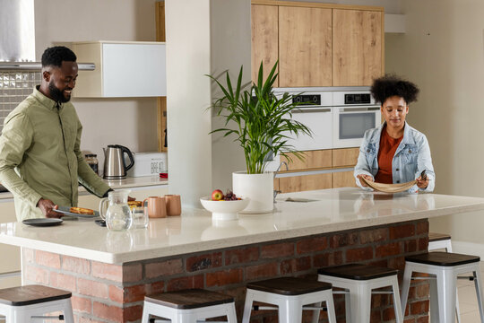 Couple preparing meal together in modern kitchen, enjoying quality time