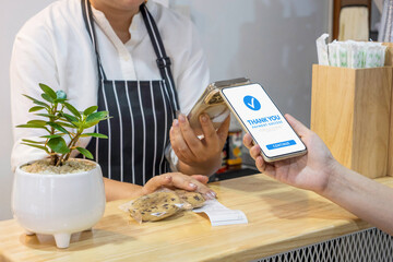 customer using smartphone for payment at cafe restaurant by mobile digital wallet. cashless society, QR code scanning and money transfer via mobile banking concept