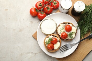 Tasty stuffed mushrooms served on light table, flat lay. Space for text