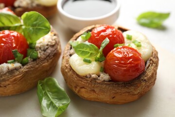 Tasty stuffed mushrooms served on light table, closeup