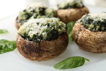 Tasty stuffed mushrooms served on table, closeup