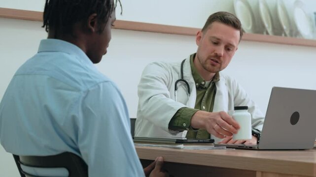 Healthcare provider doctor explaining medication details to african american patient, offering personalized treatment advice with professional clarity in clinical setting