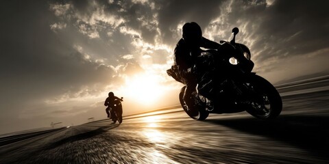 Silhouettes of Bikers Riding Speed Motorcycle on Empty Road at Dusk