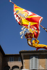 flag on the roof of a building in siena