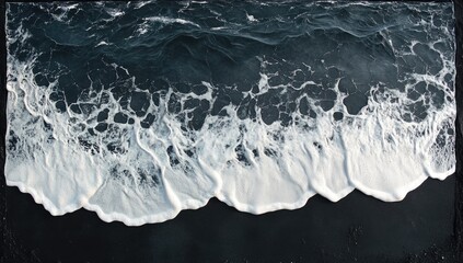 Dark ocean waves on black sand