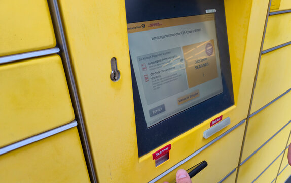Lahde, Germany - April 15 2025: Close-up of a modern parcel locker screen showing options for scanning shipment numbers or QR codes at a postal service location.