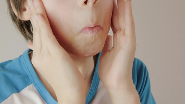 teenage boy applying acne cream, Teen boy focused on facial skincare, highlighting self-image issues and teenage skin concerns