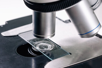 Close-up of scientific microscope with glass, analyzing data in lab, research for vaccine production. Concept of biological sciences and virology.