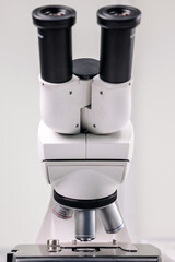 A biologist or virologist conducts diagnostic studies by working with a close-up microscope....