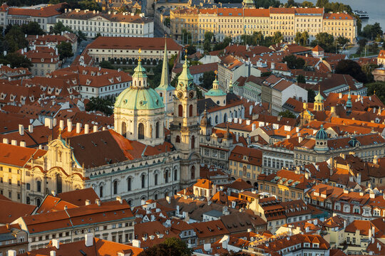 St Nicholas Church stands majestically in the Prague skyline, surrounded by the warm glow of sunset