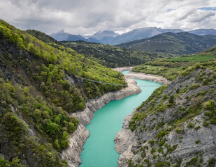 Himalayan footbridge over Lake Monteynard-Avignonet in the French Alps near Grenoble, suspended walkway in scenic mountain landscape, popular hiking destination