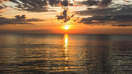 sunset over the sea sunshine coming over the clouds.