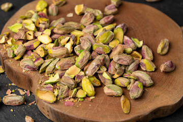 green pistachios peeled from the shell, salted crunchy nuts, pistachios without shells, cut into small and large pieces