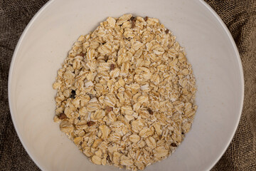 fruits with oatmeal porridge, dried fruits and berries to give a pleasant taste to the finished oatmeal, close up