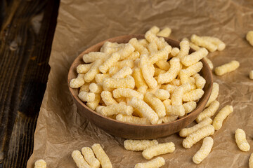 corn sticks made from corn flour, a large number of ready-made corn sticks for eating or making breakfast with milk, corn sticks in a wooden bowl