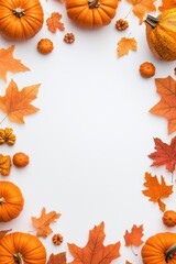 Autumnal pumpkins and leaves frame a white background