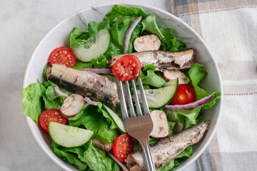 garden salad  top with  mushrooms and sardines