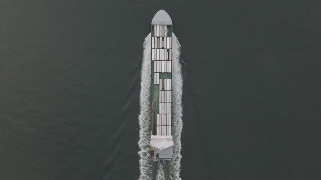 Top down aerial view of cargo ship. Global trade and maritime shipping concept.
