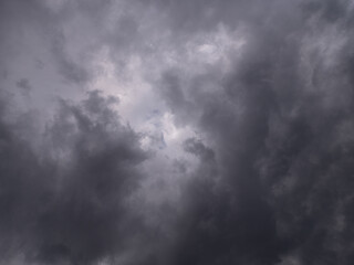 Dark storm clouds cover the sky with a small bright opening in the center. A dramatic natural scene often linked to spiritual symbolism, faith, and the presence of light in darkness.