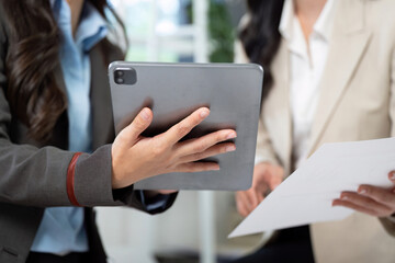 Digital Transformation in Business. Professionals reviewing data on a tablet during a meeting.