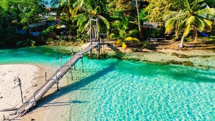 Serene retreat at Koh Kood with turquoise waters and lush palm trees under a clear blue sky