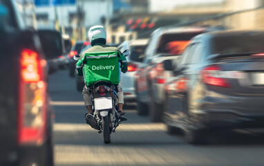 Delivery driver on a motorcycle weaving through heavy urban traffic, symbolizing fast service and...