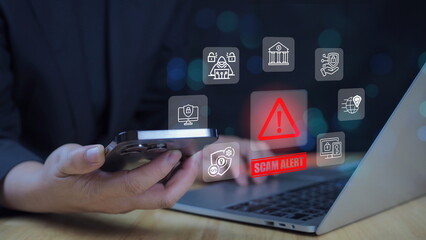Scam alert warning. cybersecurity concept. Woman using laptop, warning sign for scams with icons representing online threats, phishing, and cybersecurity.
