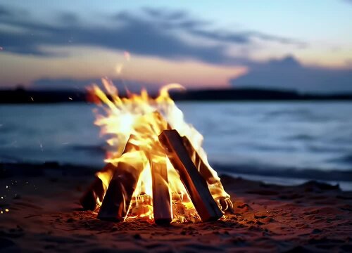A cozy bonfire crackles on a sandy shore by a calm lake during twilight. The sky glows with deep blue and orange hues as the sun sets behind soft clouds.